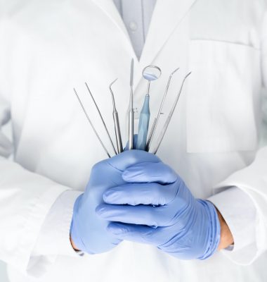 close-up-of-dentist-hands-with-dental-equipment.jpg